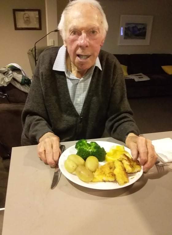 An older gentleman enjoying a freshly prepared dinner at home
